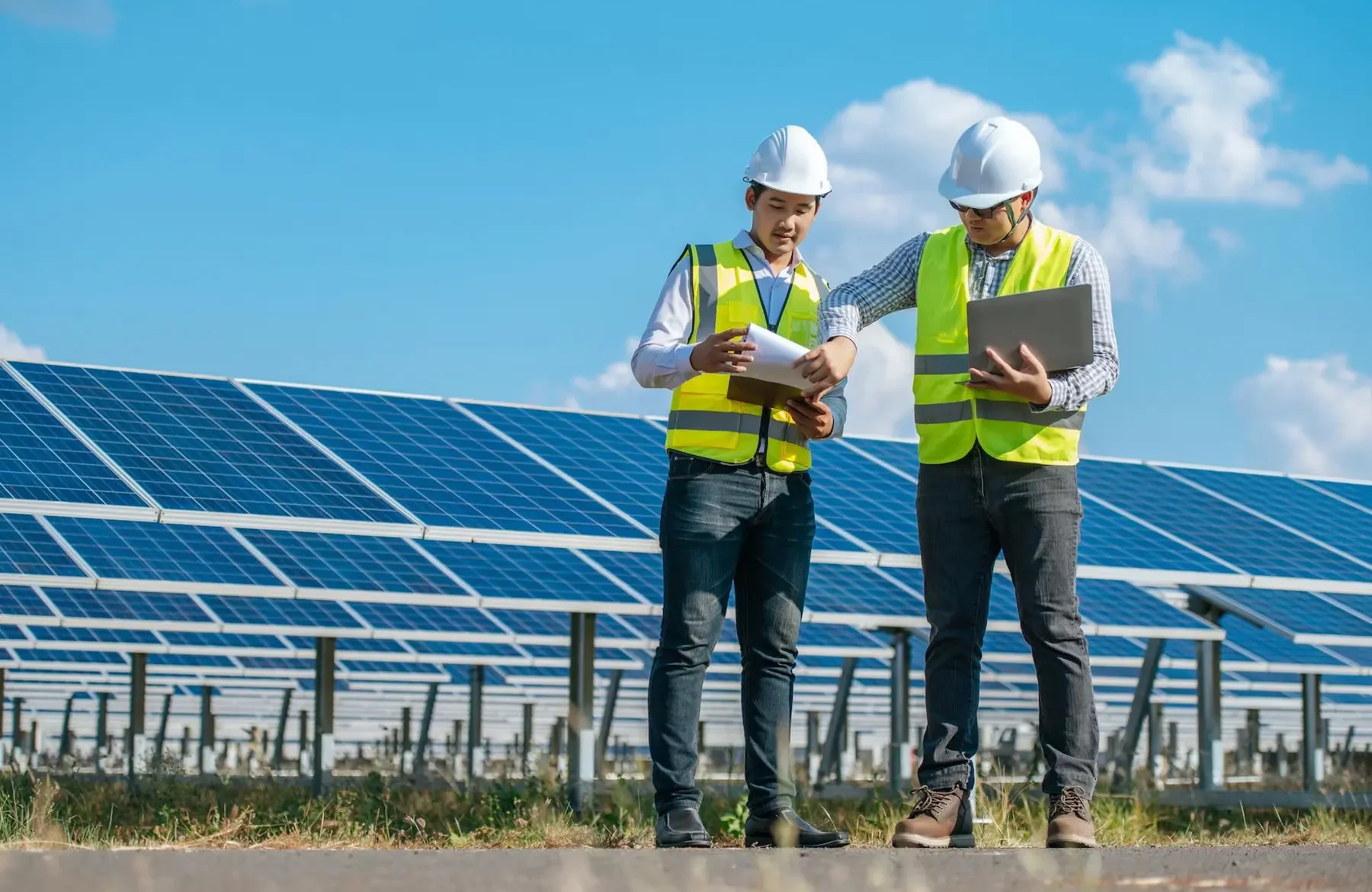 two-asian-young-engineers-walking-along-rows-photovoltaic-panels-solar-farm-they-use-laptop-computer-talking-together_1150-57228 photovoltaic-panels-solar